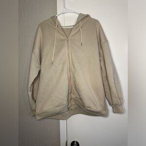 Beige zip up sweater.